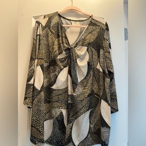 Gently worn woman’s blouse with unique neckline.